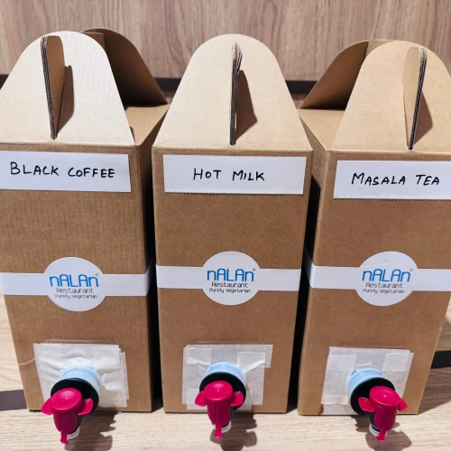 Individual high tea catering containers in Singapore with neatly packed refreshments for office meetings and events.